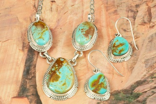 Genuine Manassa Turquoise set in Sterling Silver. Beautiful Necklace and Earrings Set. This Turquoise is also referred to as King�s Manassa Turquoise. The Manassa Turquoise mine is located in Manassa, Conejos County, Colorado. Created by Navajo Artist Kathy Yazzie. Signed by the artist.